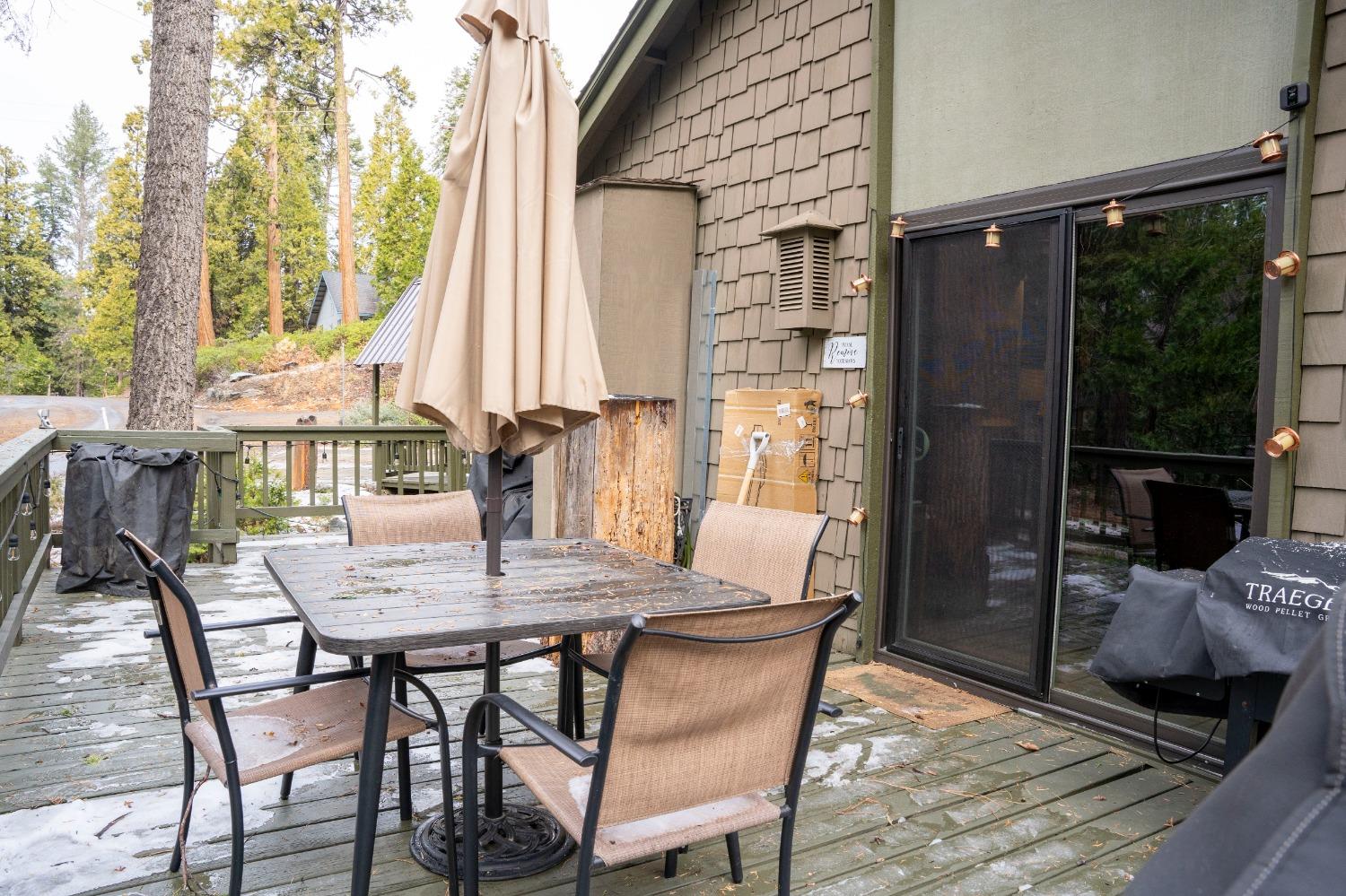 42135 Hanging Branch Road Shaver Lake, CA 93664 - Photo 18 of 55 a view of an outdoor dining space with a table and chairs
