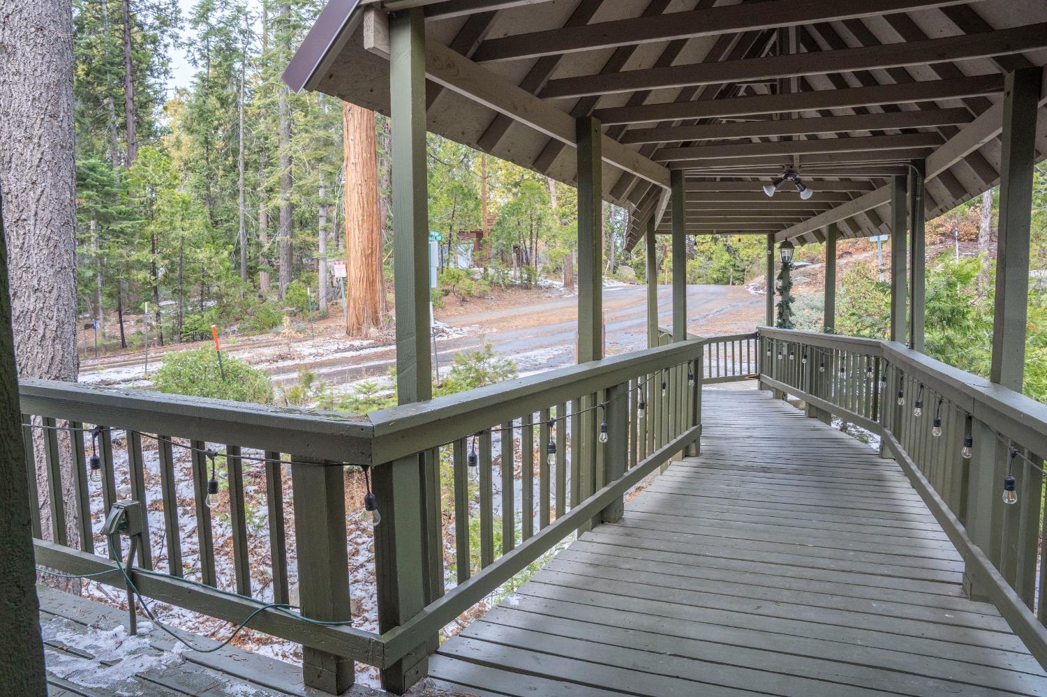 42135 Hanging Branch Road Shaver Lake, CA 93664 - Photo 19 of 55 a view of a porch with wooden floor