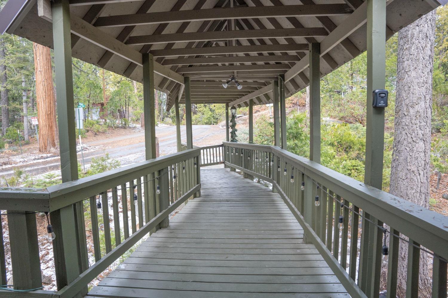 42135 Hanging Branch Road Shaver Lake, CA 93664 - Photo 20 of 55 a view of a porch with wooden floor in front door