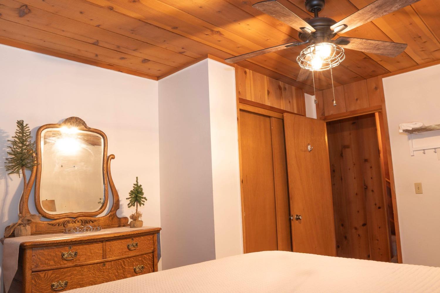 42135 Hanging Branch Road Shaver Lake, CA 93664 - Photo 48 of 55 a bedroom with a bed and a mirror