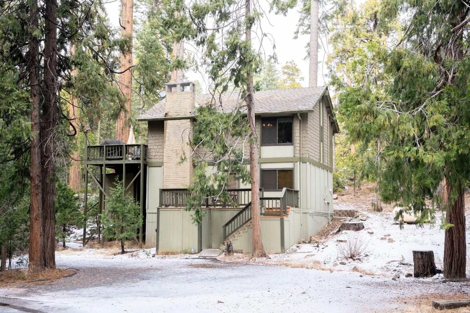 42135 Hanging Branch Road Shaver Lake, CA 93664 - Photo 10 of 55 a front view of a house with a tree