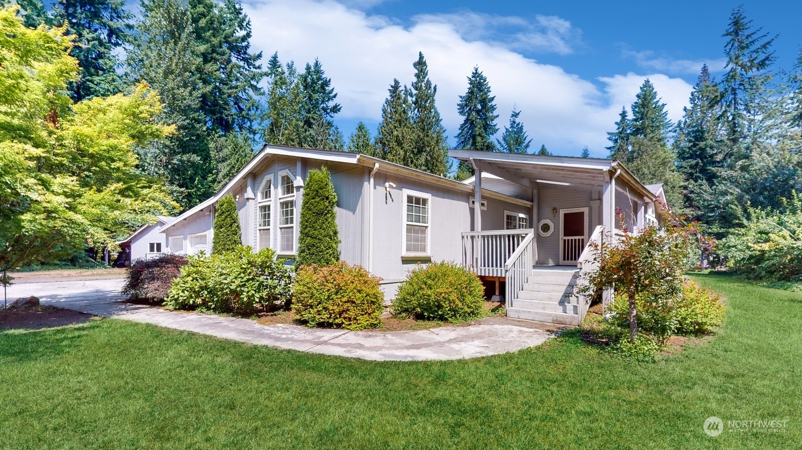 5507 189th Street Southeast Bothell, WA 98012 - Photo 1 of 37 a front view of a house with a yard and trees