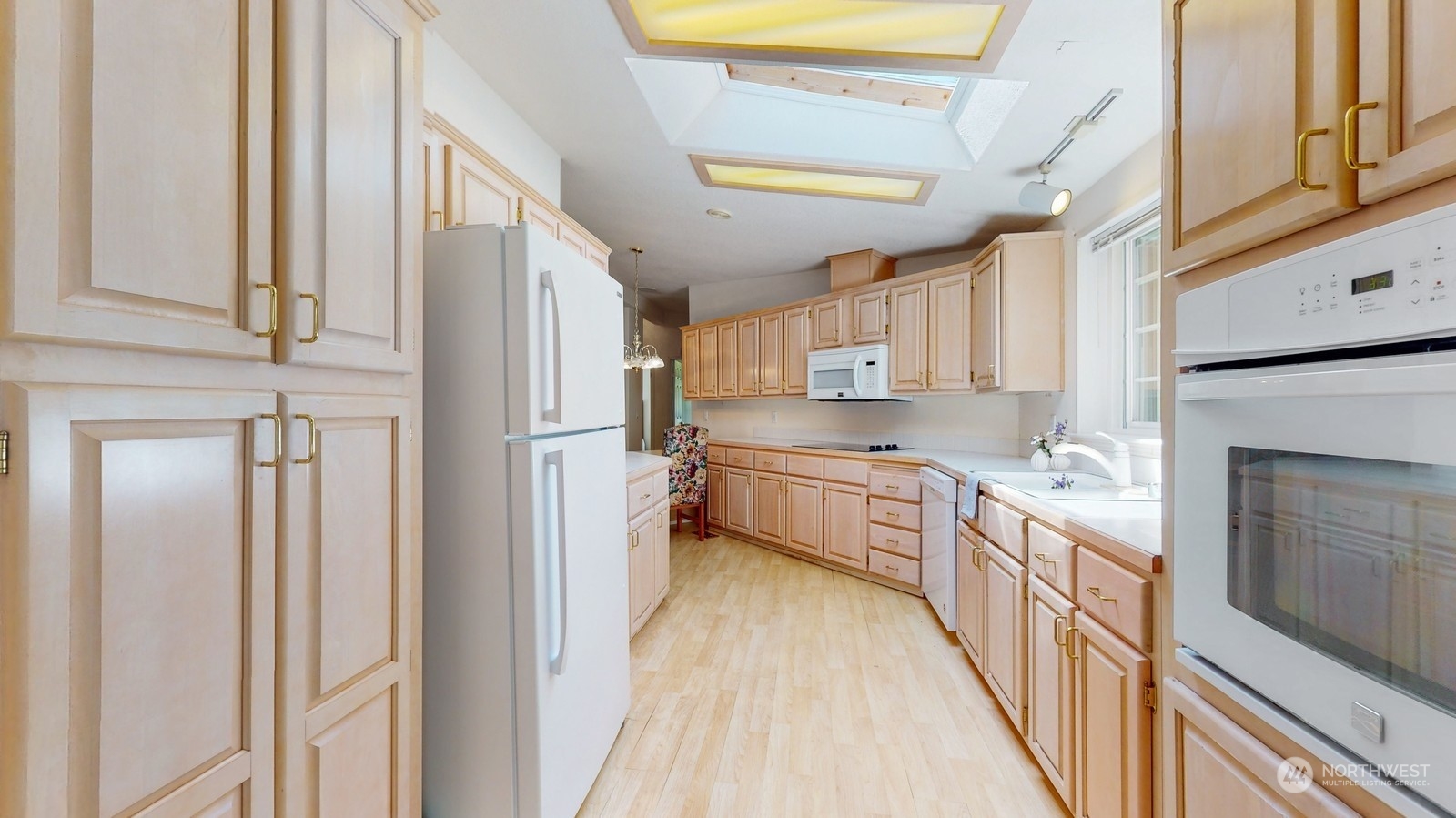 5507 189th Street Southeast Bothell, WA 98012 - Photo 13 of 37 a kitchen with stainless steel appliances granite countertop a refrigerator a stove and a sink with wooden floor