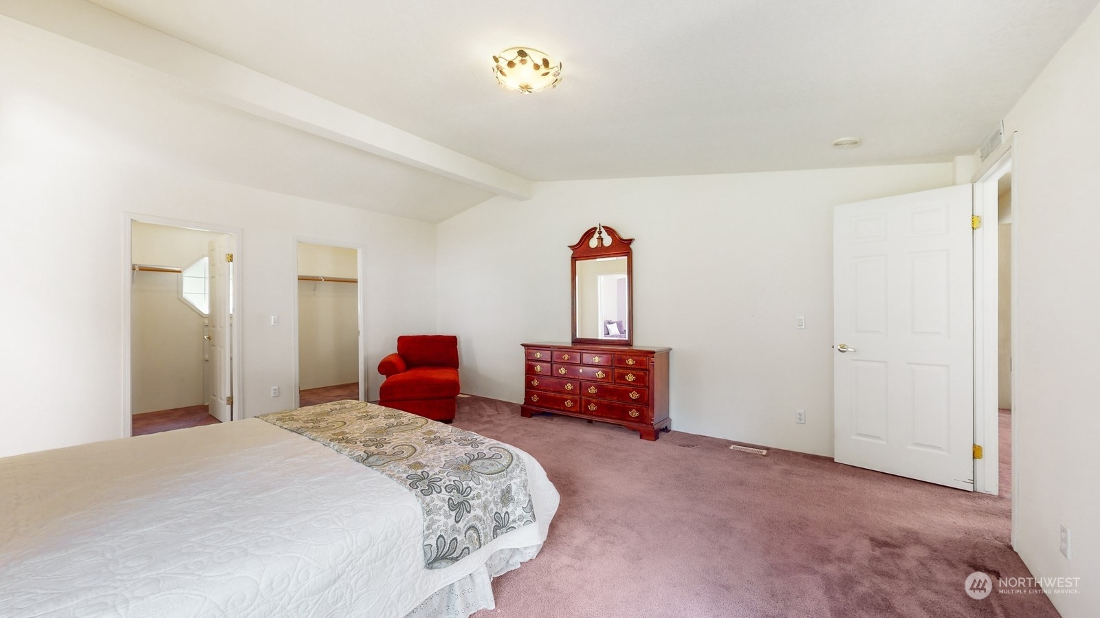 5507 189th Street Southeast Bothell, WA 98012 - Photo 27 of 37 a bedroom with bed and a chandelier