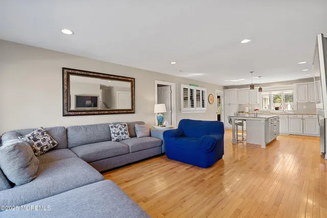 a living room with furniture and kitchen view