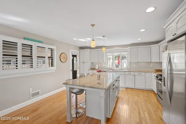 a kitchen with a sink stove and refrigerator
