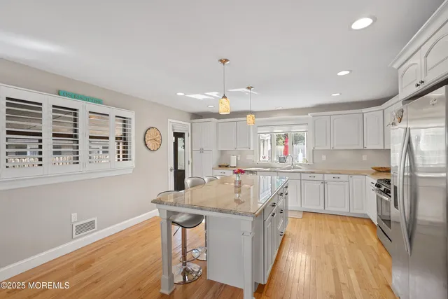 a kitchen with a sink stove and refrigerator