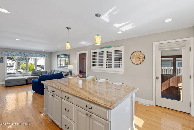 a kitchen with granite countertop a stove and a sink