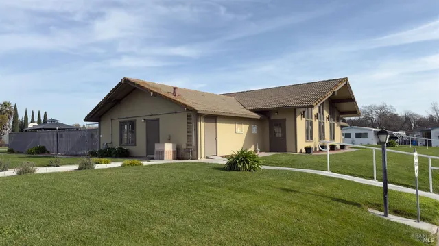 a backyard of a house with table and chairs