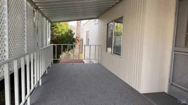a view of a porch with wooden floor and stairs