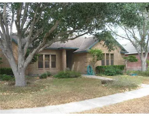 a front view of a house with a yard and shrubs