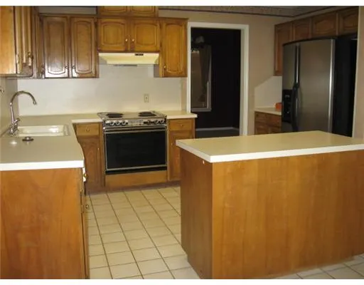a kitchen with stainless steel appliances a refrigerator a sink a stove and dishwasher