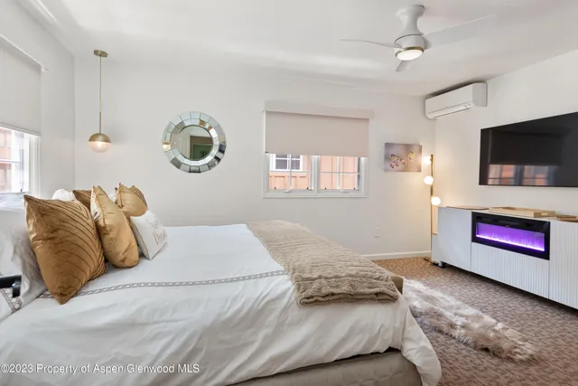 a bedroom with a bed and a flat screen tv
