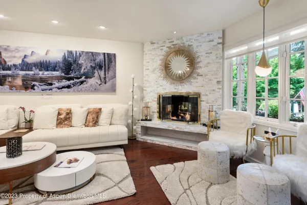 a living room with furniture and a fireplace