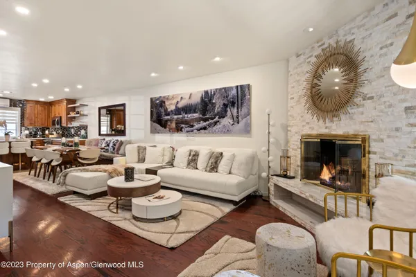 a living room with furniture and a fireplace