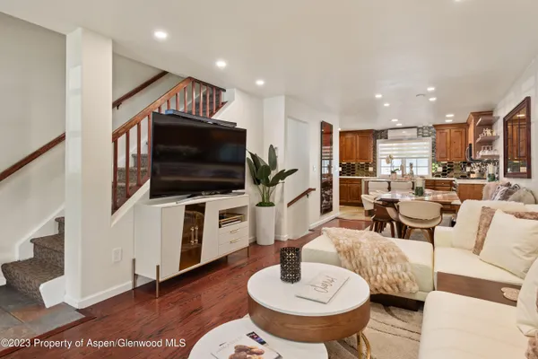 a living room with furniture and a flat screen tv