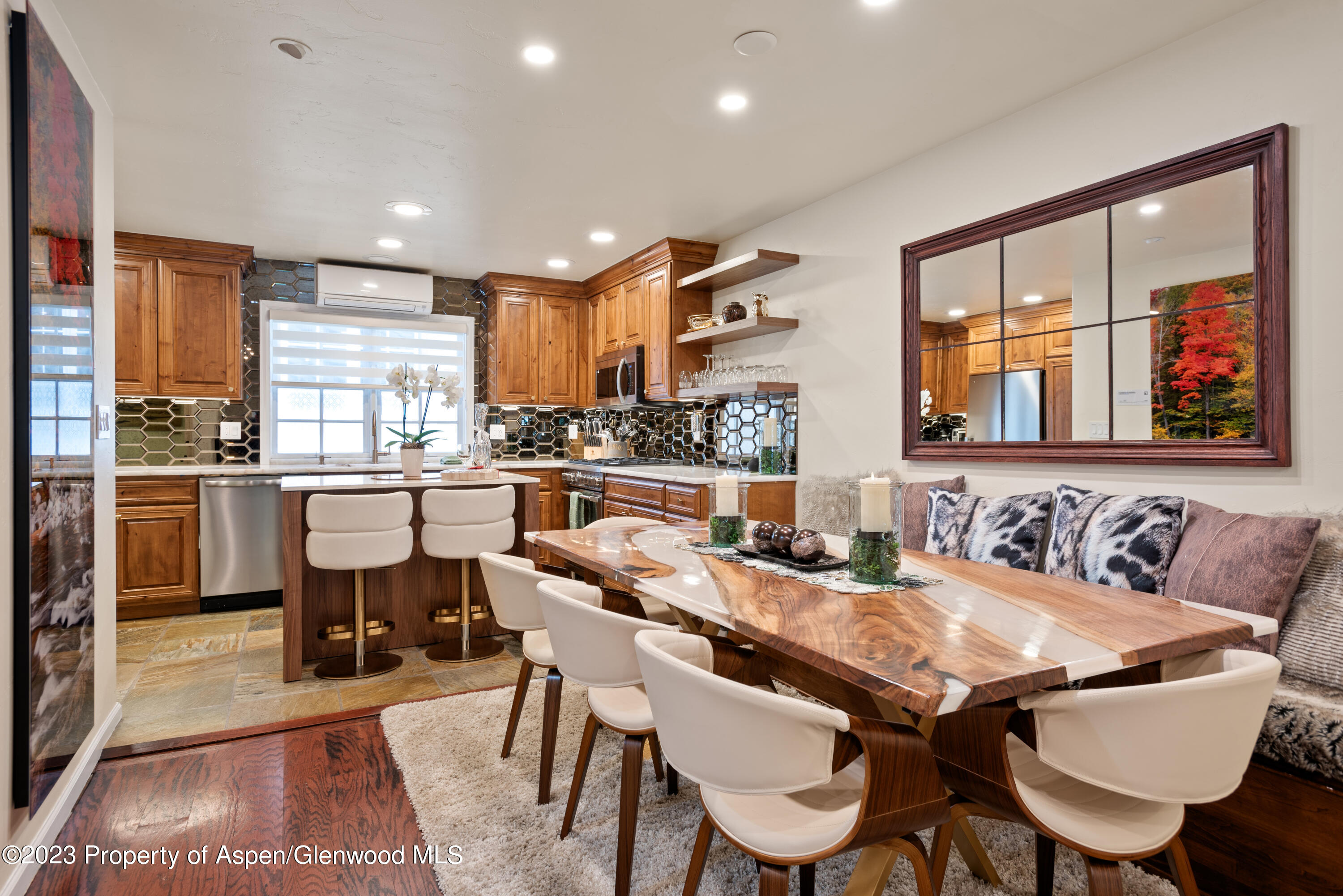 711 South Galena Street, Unit 20D Aspen, CO 81611 - Photo 7 of 26 a view of a dining room with furniture large windows and wooden floor