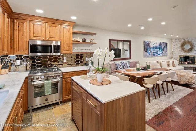 a kitchen with lots of counter top space a sink appliances and cabinets
