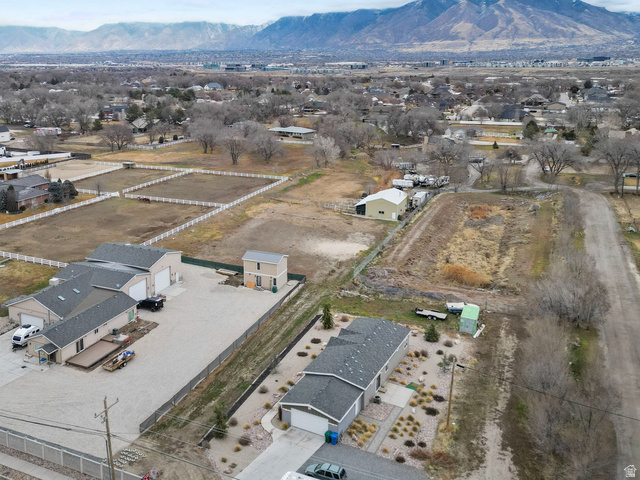 13567 South Redwood Road Riverton, UT 84065 - Photo 3 of 6 Aerial view of residential area with a mountain backdrop