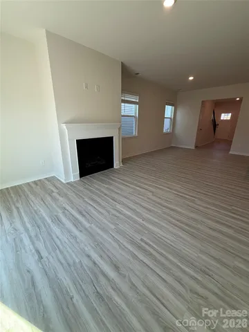 a view of empty room with a fireplace