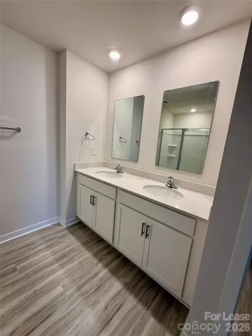 a spacious bathroom with a double vanity sink and a mirror