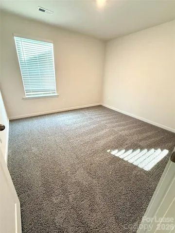 a spacious bathroom with a double vanity sink a mirror and a bathtub