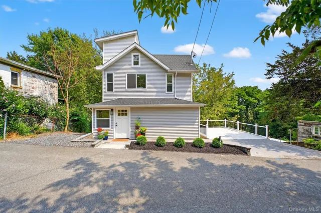 a view of a house with backyard and sitting area