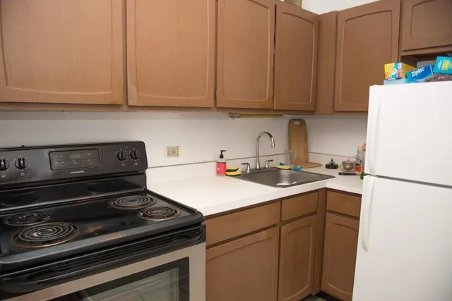 a kitchen with a sink a stove and cabinets
