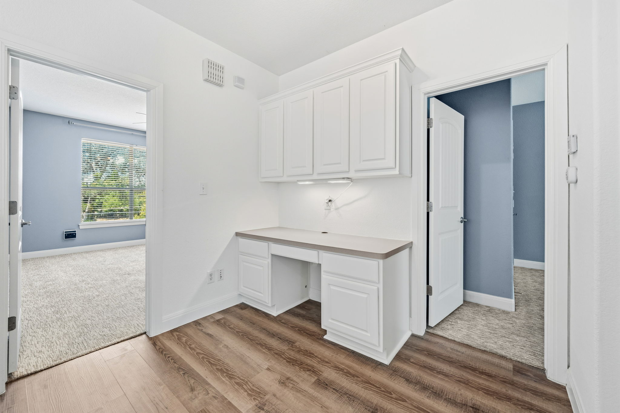 6708 Manchaca Road, Unit 4 Austin, TX 78745 - Photo 14 of 25 A built-in desk alcove with overhead cabinetry anchors this versatile transition space.