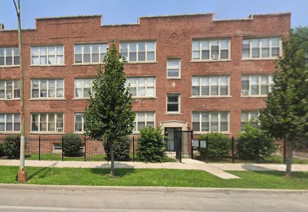 a front view of a residential apartment building with a yard