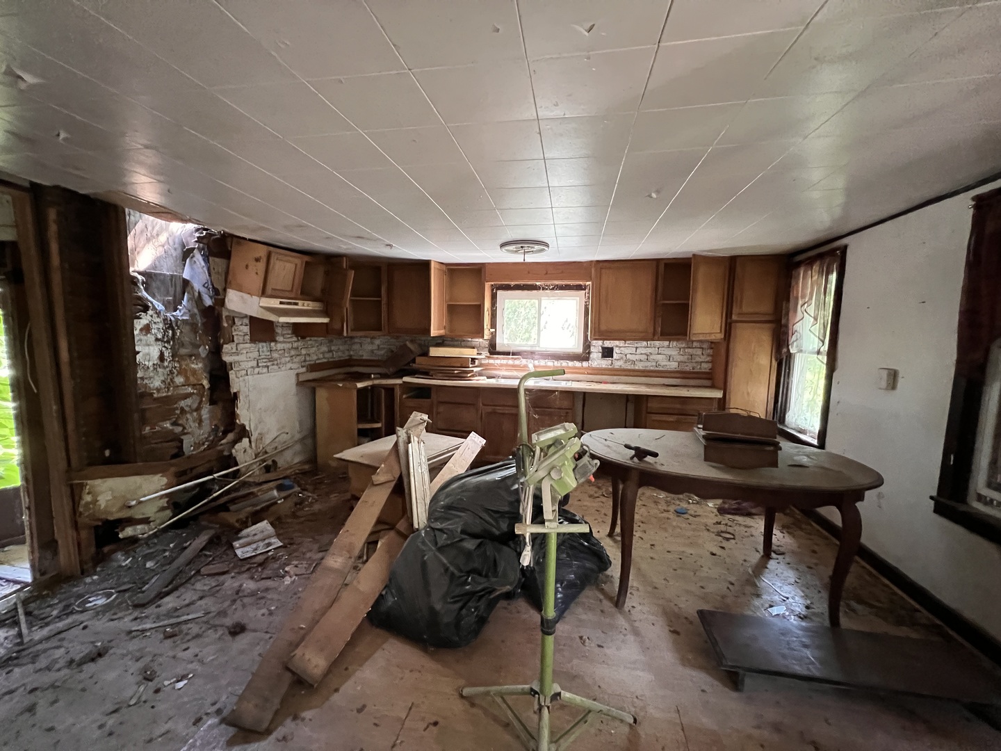1099 Lost Nation Road Dixon, IL 61021 - Photo 6 of 13 a kitchen with stainless steel appliances a stove a sink dishwasher a refrigerator white cabinets and wooden floor