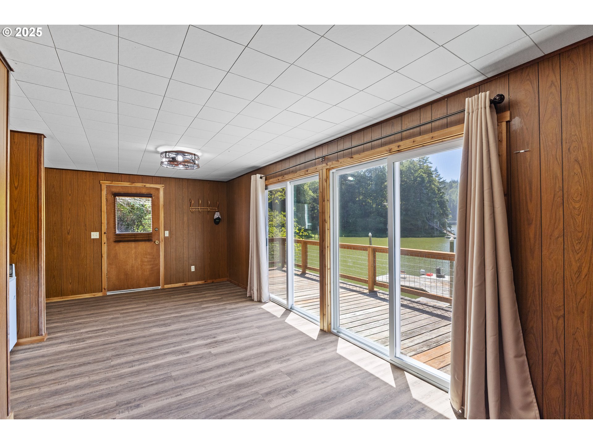 1523 North Tenmile Lakeside, OR 97449 - Photo 15 of 26 a view of an empty room with wooden floor and a window