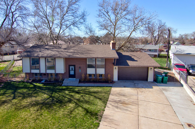 958 East 175 South Layton, UT 84041 - Photo 1 of 1 View of front of house featuring driveway, a chimney, an attached garage, roof with shingles, and brick siding