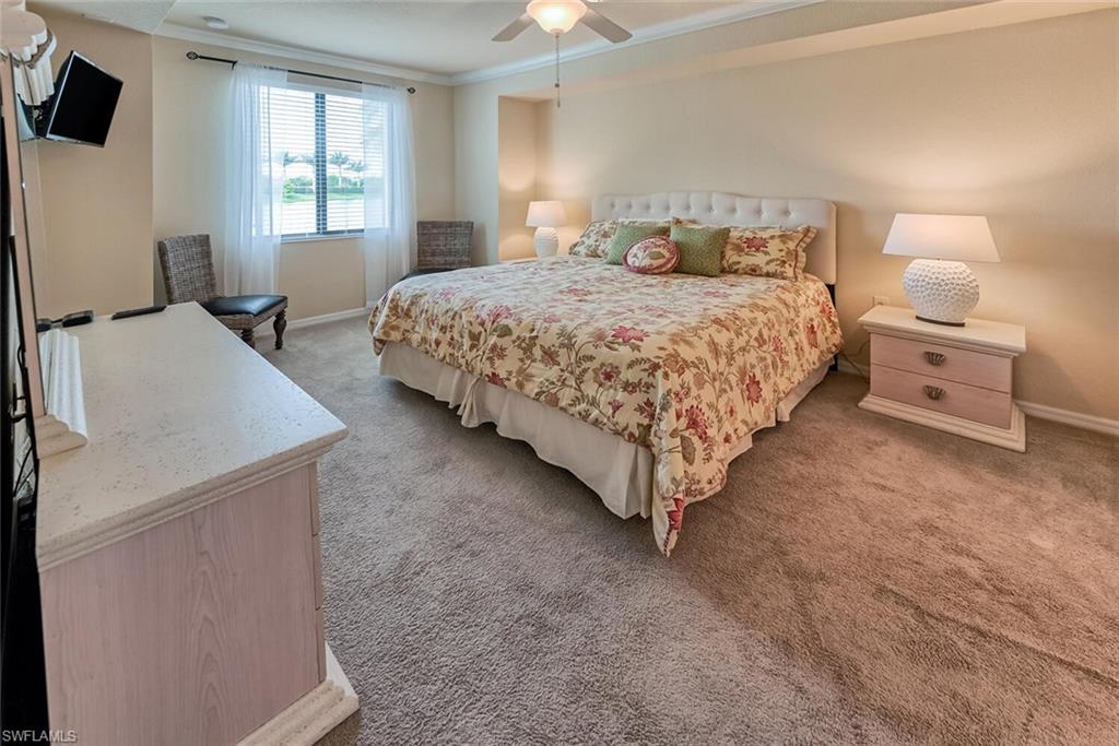9528 Avellino Way, Unit 2515 Naples, FL 34113 - Photo 14 of 35 a bedroom with a bed and a window