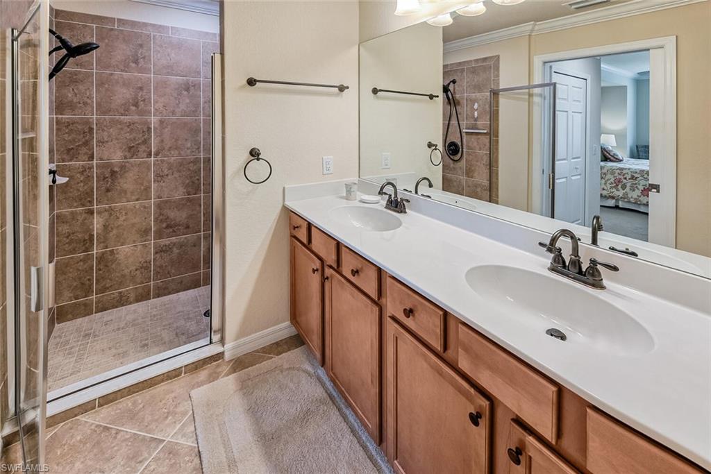 9528 Avellino Way, Unit 2515 Naples, FL 34113 - Photo 15 of 35 a bathroom with a double vanity sink mirror and shower