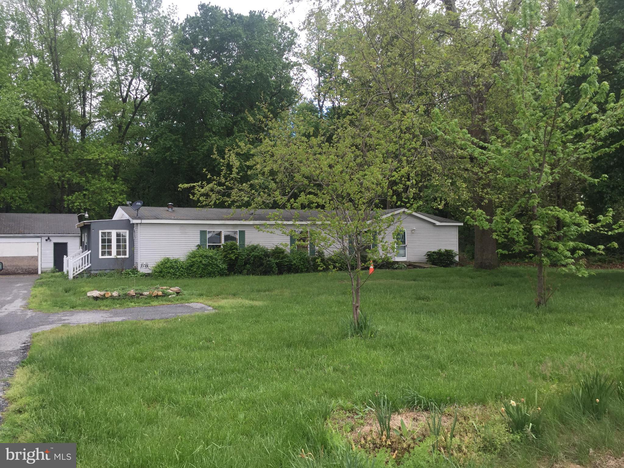 4970 Harmony Road Preston, MD 21655 - Photo 1 of 18 a front view of a house with garden