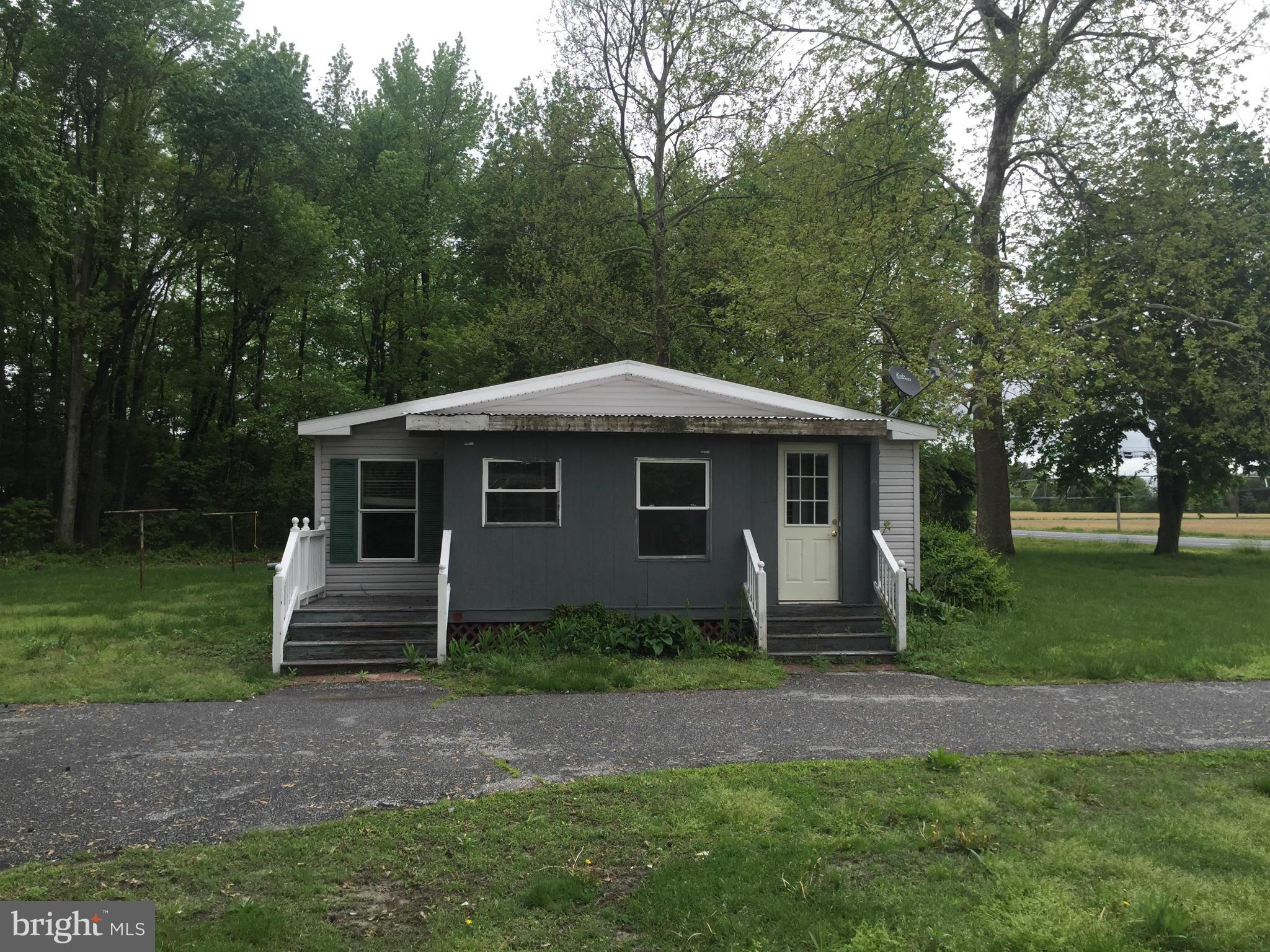 4970 Harmony Road Preston, MD 21655 - Photo 2 of 18 a front view of a house with a yard