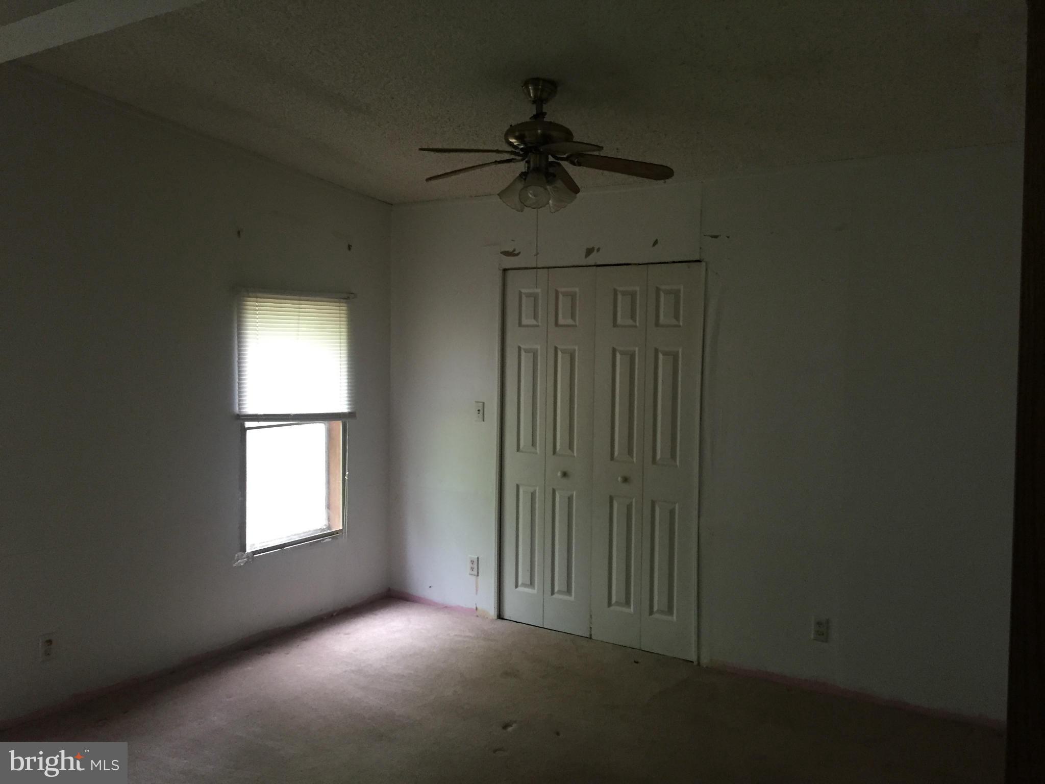4970 Harmony Road Preston, MD 21655 - Photo 11 of 18 an empty room with windows and fan