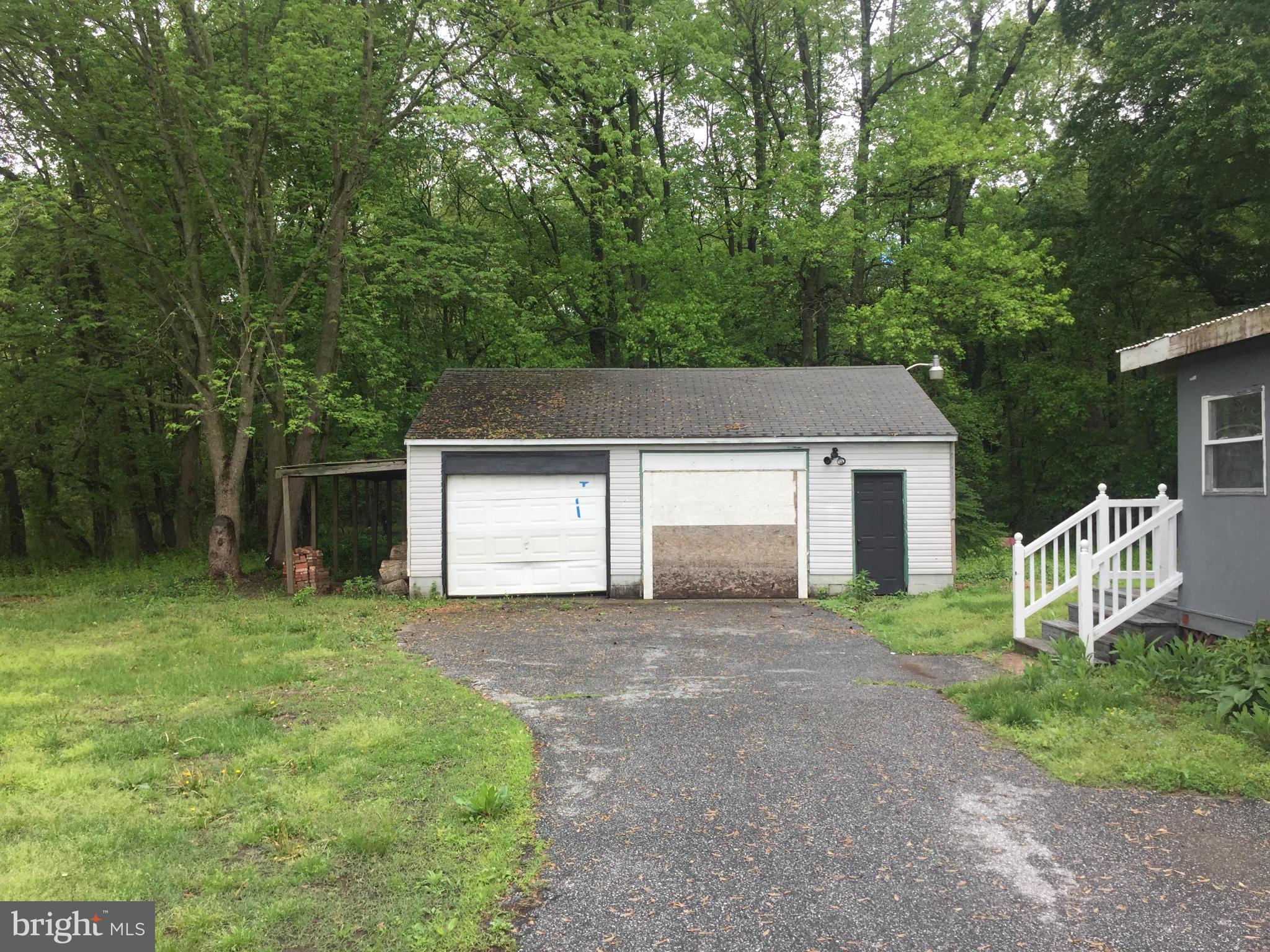 4970 Harmony Road Preston, MD 21655 - Photo 5 of 18 a front view of a house with a yard and garage