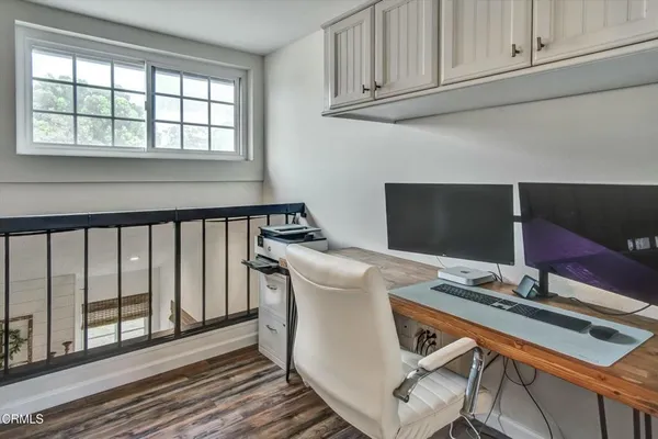 a work place with furniture and wooden floor