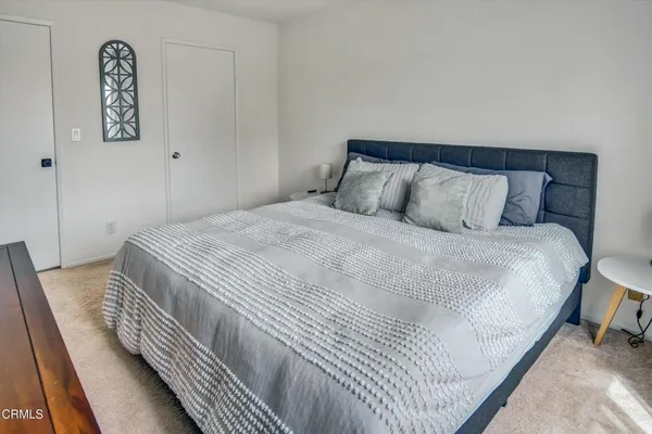 a bedroom with a bed and a night stand