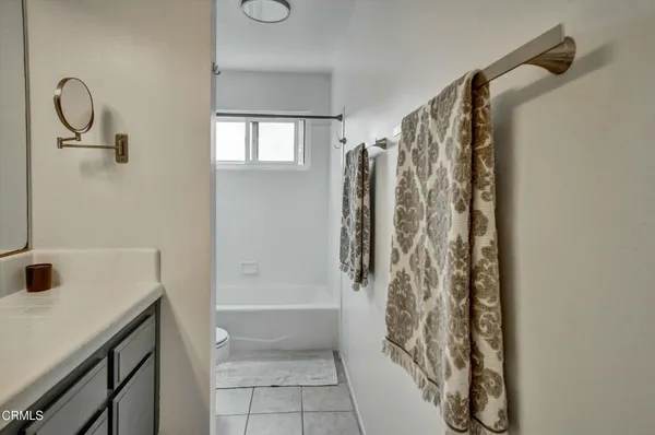 a bathroom with a shower curtain and a window