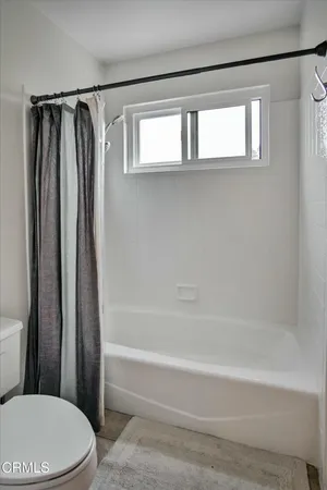 a bathroom with a toilet and a bathtub