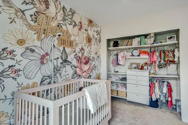 a bedroom with a wooden floor and book shelf