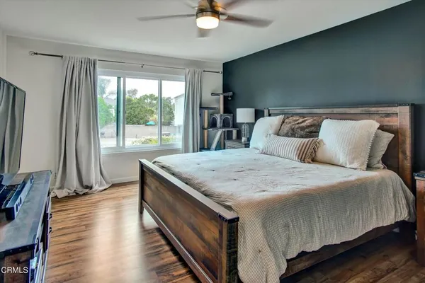 a bed sitting in a bedroom next to a window