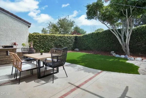 a view of a backyard with sitting area