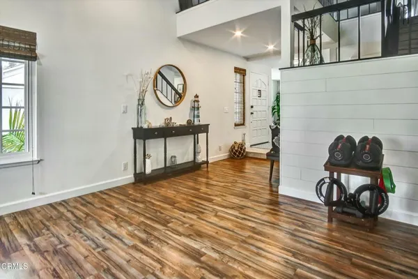a view of a livingroom with furniture and a hardwood floor