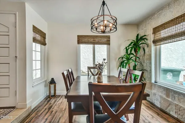 a view of a dining room with furniture window and wooden floor