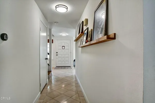 a view of a hallway with paintings on the wall