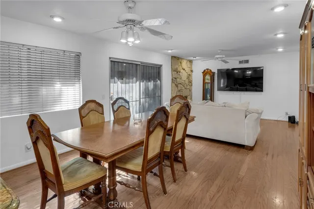 a view of a dining room with furniture and wooden floor